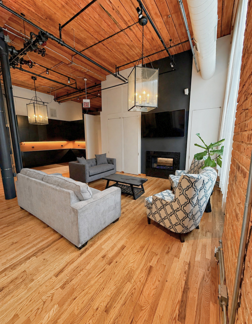 1327 West Washington Boulevard, Unit 106 Chicago, IL 60607 - Photo 5 of 23 a living room with furniture and a fireplace