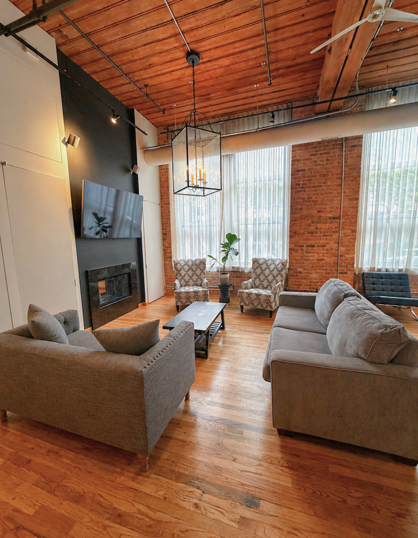 1327 West Washington Boulevard, Unit 106 Chicago, IL 60607 - Photo 6 of 23 a living room with furniture and a large window