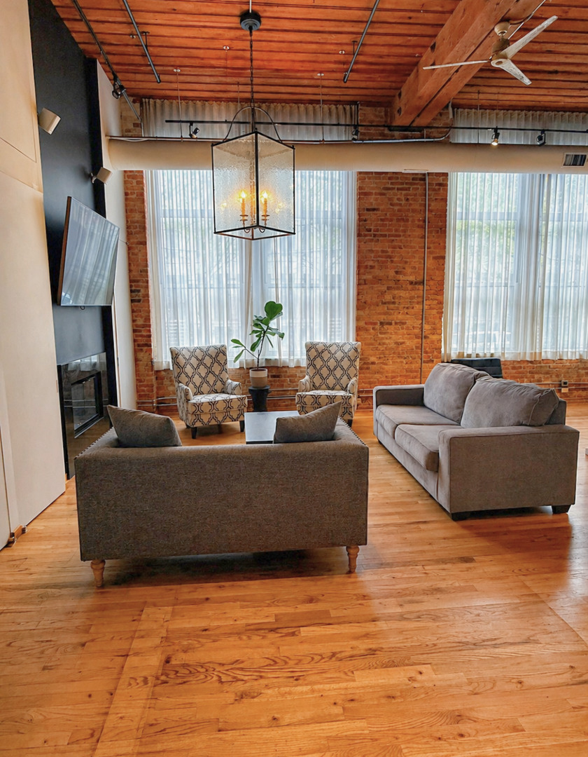 1327 West Washington Boulevard, Unit 106 Chicago, IL 60607 - Photo 7 of 23 a living room with furniture and a large window