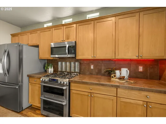 a kitchen with appliances cabinets and a sink