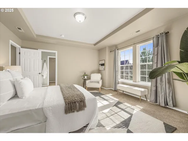 a bedroom with a bed and a large window