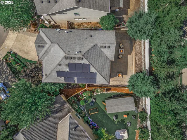 an aerial view of a house with a yard and potted plants