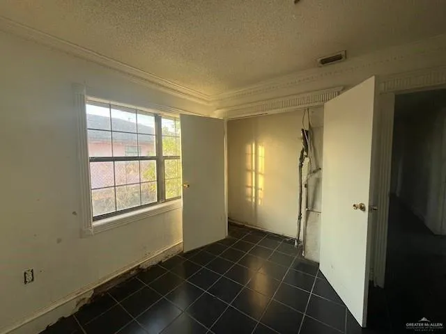 a view of an empty room and a window