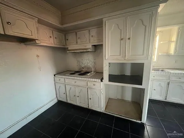 a kitchen with stainless steel appliances white cabinets and a sink