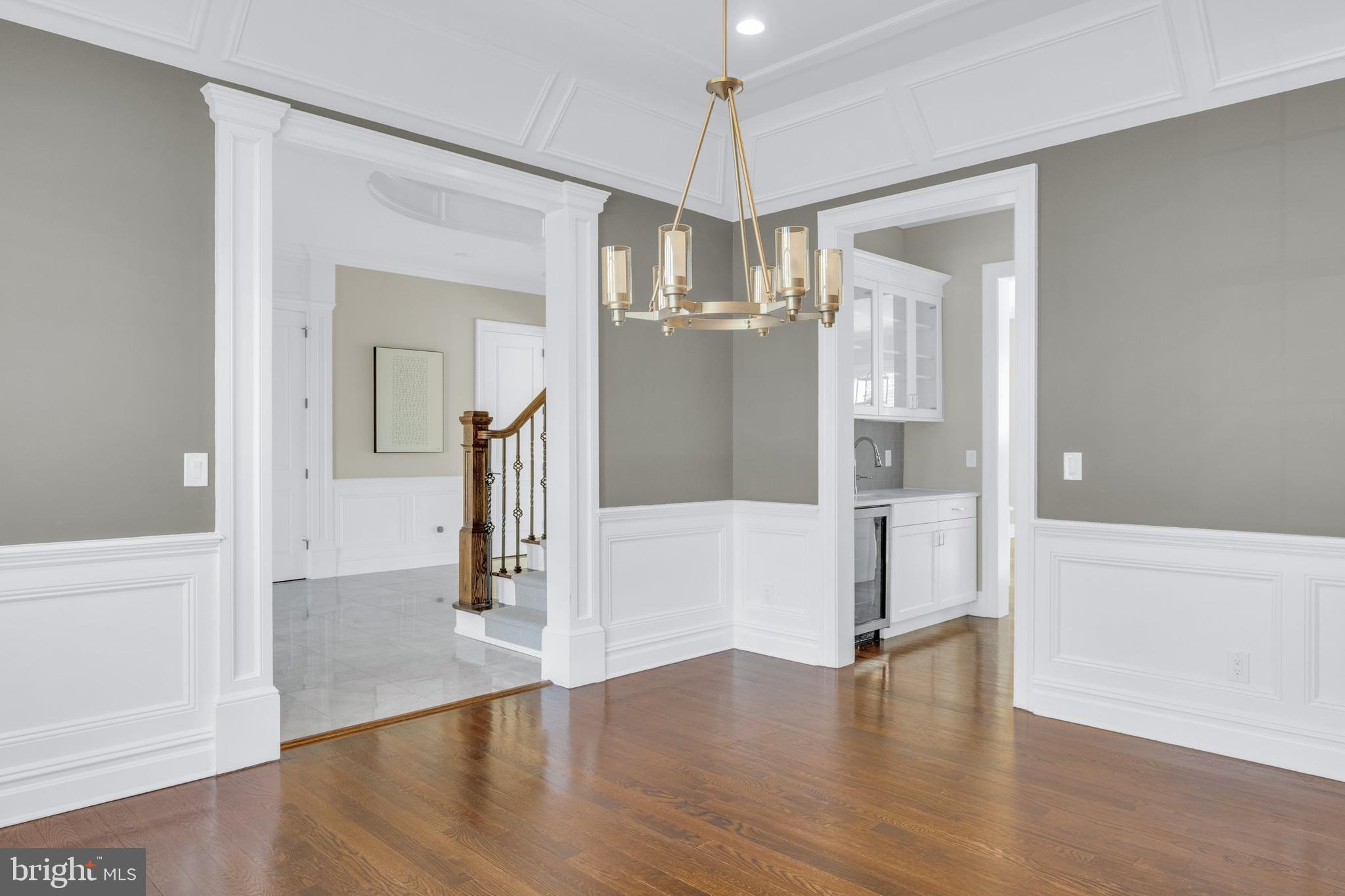 151 Sycamore Road Princeton, NJ 08540 - Photo 8 of 46 a view of a hallway with wooden floor and chandelier