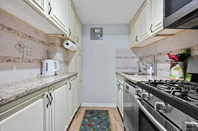 a kitchen with stainless steel appliances granite countertop a stove and cabinets