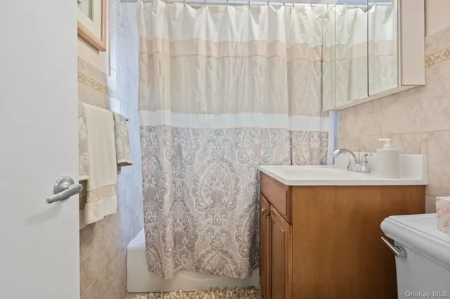a bathroom with a sink vanity and toilet