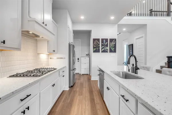 a large kitchen with cabinets and a stove