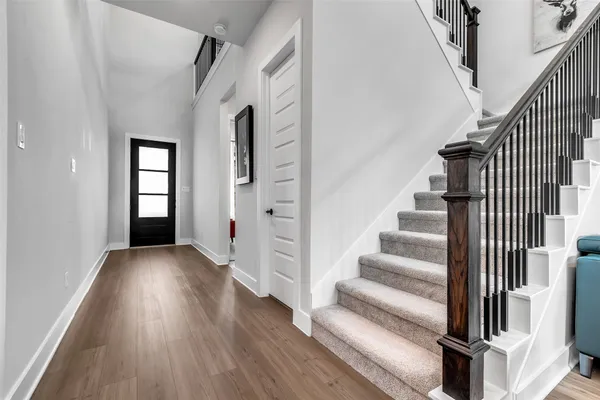 a view of an entryway with wooden floor and stairs
