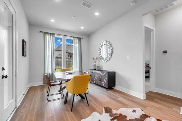a view of a livingroom with furniture wooden floor and a window