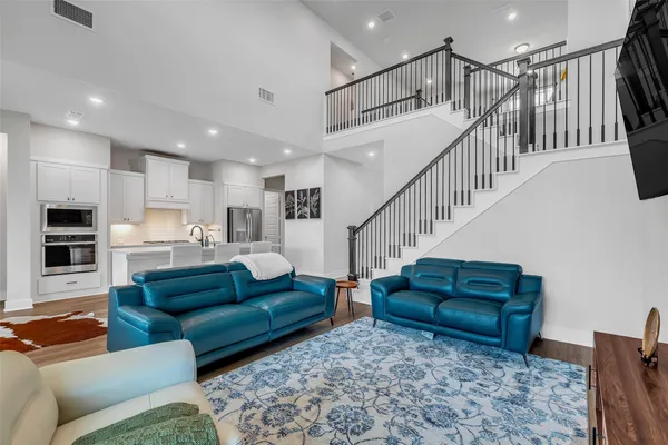 a living room with furniture or stairs and a rug