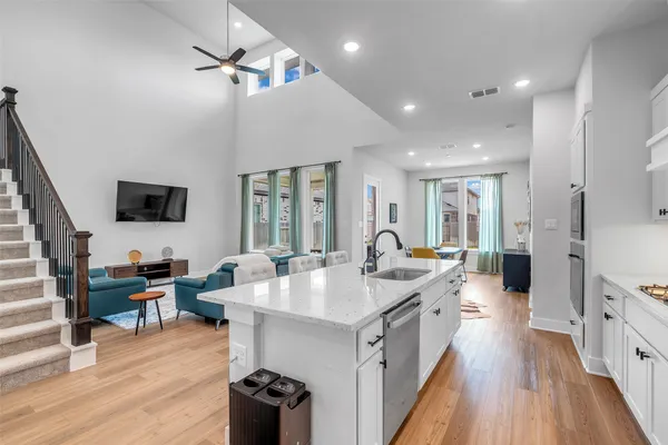 a kitchen with stainless steel appliances granite countertop a sink stove and wooden floor