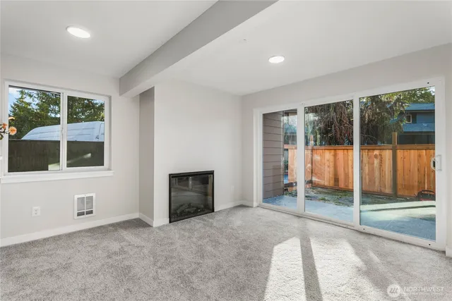 an empty room with floor to ceiling windows and an outdoor view