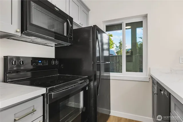 a kitchen with a stove microwave and refrigerator