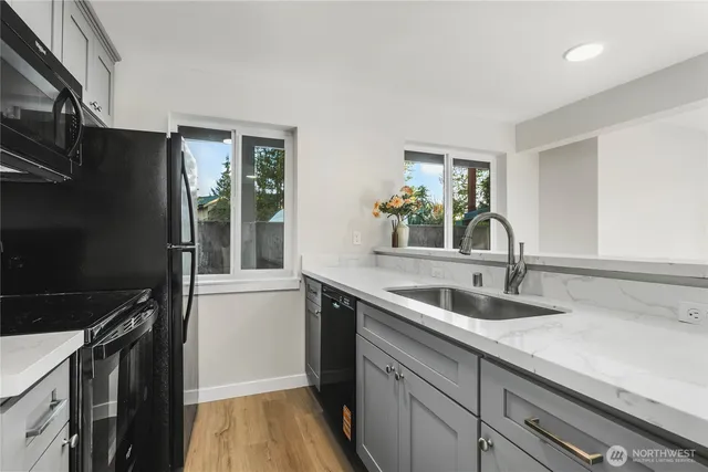 a kitchen with a sink appliances and cabinets
