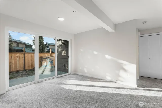 a view of kitchen with furniture and refrigerator