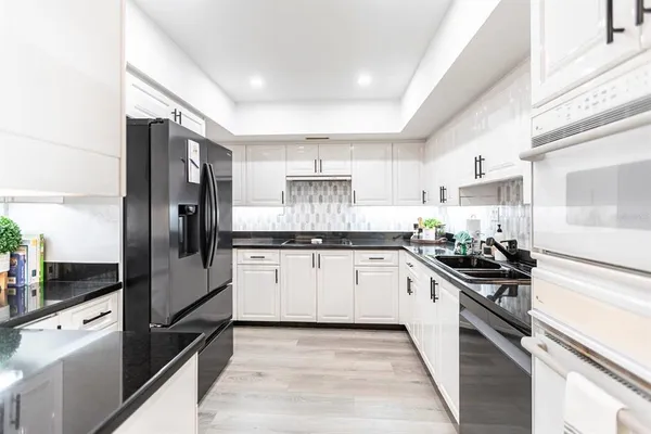 a kitchen with a sink stainless steel appliances and cabinets