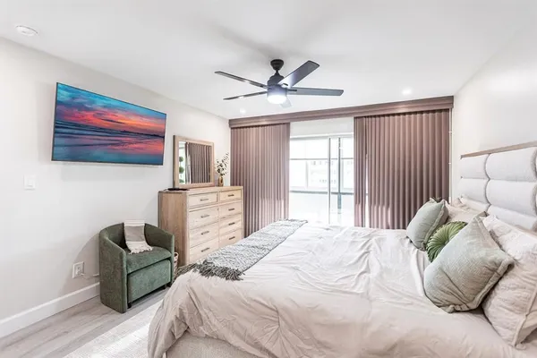 a bedroom with furniture and a large window