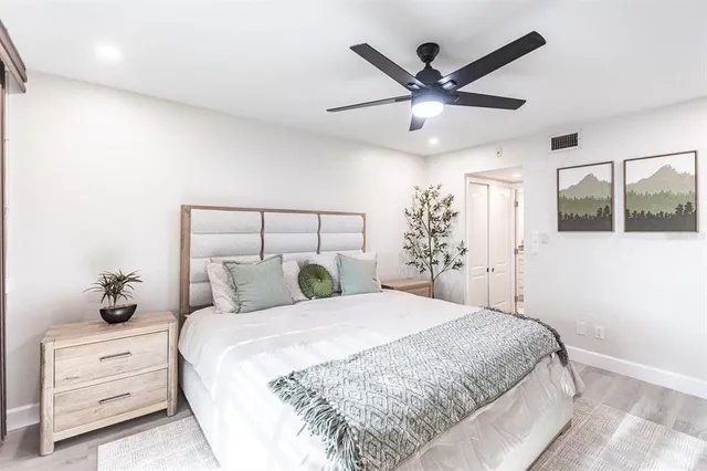 a bedroom with a large bed and a chandelier