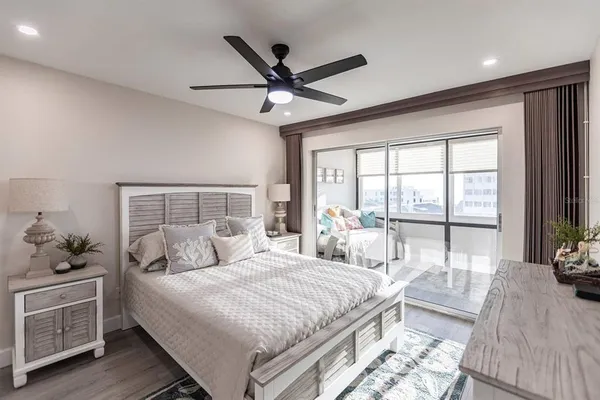 a bedroom with a large bed and a large window