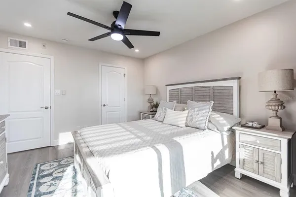 a bedroom with a bed and a chandelier