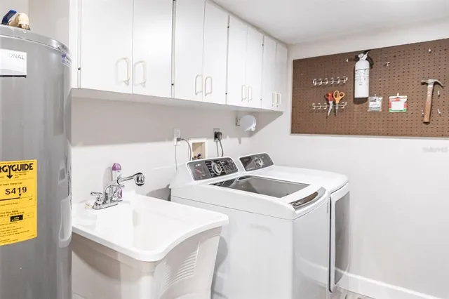 a kitchen with a sink a stove and cabinets