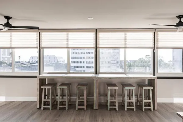a view of a room with wooden floor and furniture