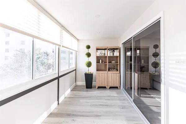 a view of a large room with wooden floor and windows