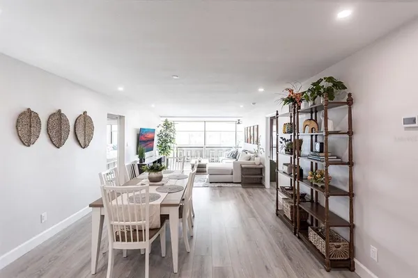 a view of a dining room with furniture window and wooden floor