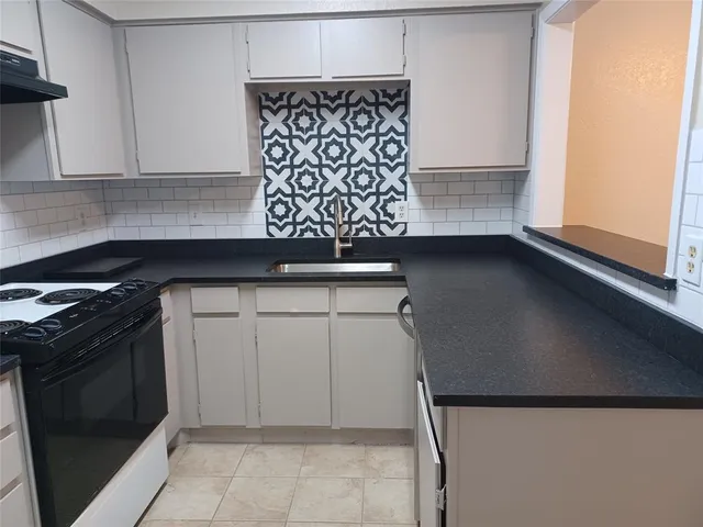 a stove top oven sitting inside of a kitchen