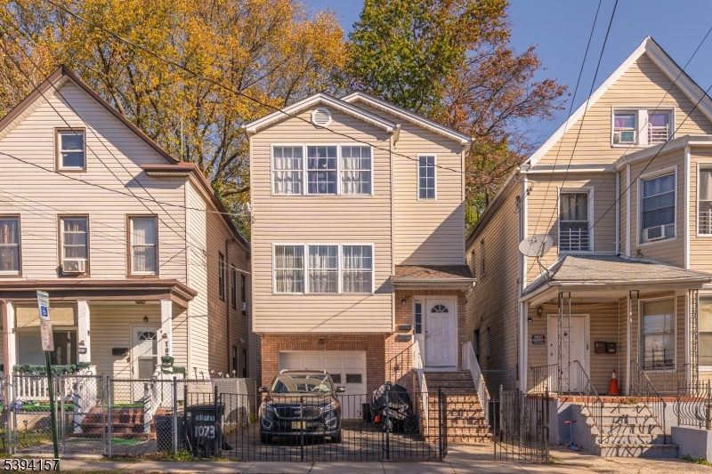 1073 Bond Street Elizabeth, NJ 07201 - Photo 2 of 30 a front view of a residential apartment building with a yard