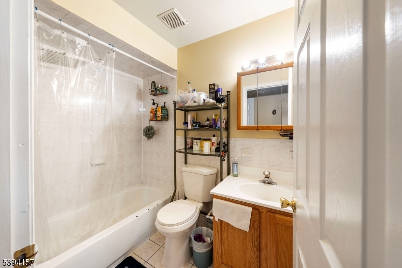 1073 Bond Street Elizabeth, NJ 07201 - Photo 23 of 30 a bathroom with a sink a toilet and shower