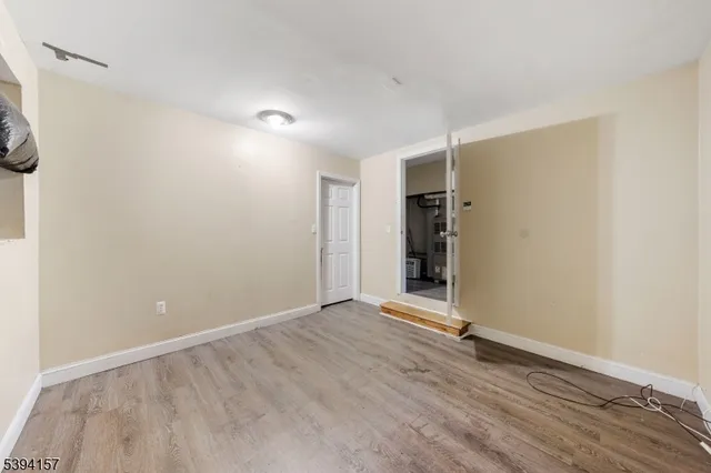 a view of a small space with wooden floor and a window