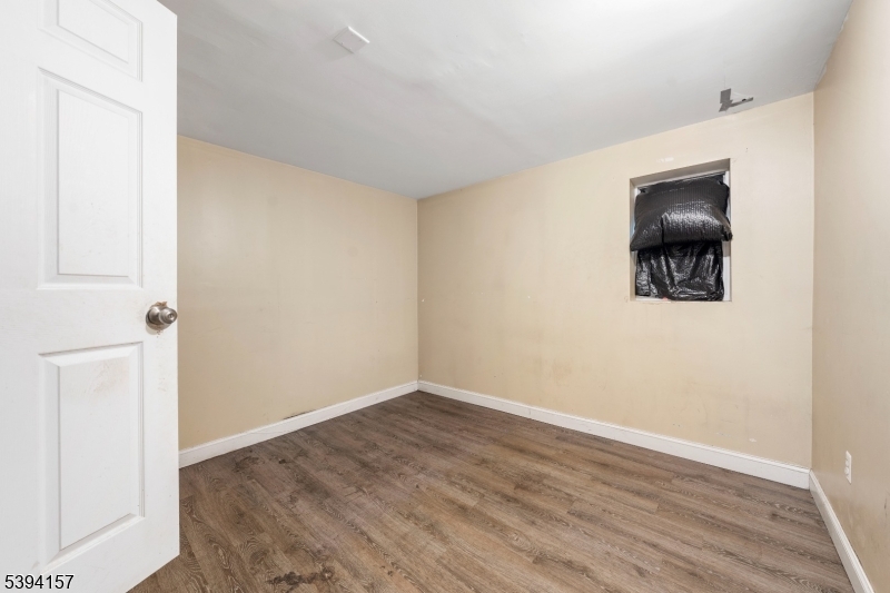 1073 Bond Street Elizabeth, NJ 07201 - Photo 27 of 30 a view of a small space with wooden floor and a window