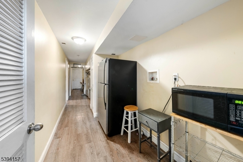 1073 Bond Street Elizabeth, NJ 07201 - Photo 28 of 30 a view of a hallway with wooden floor and staircase