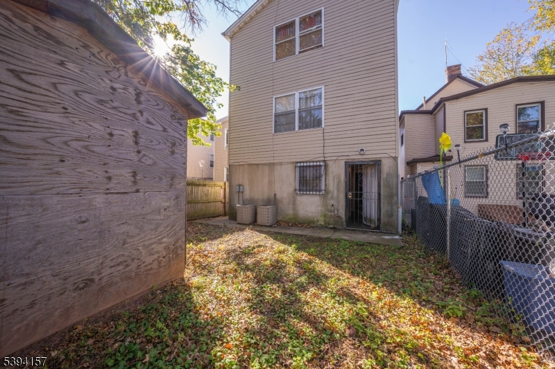 1073 Bond Street Elizabeth, NJ 07201 - Photo 30 of 30 a view of a house with a small yard and wooden fence
