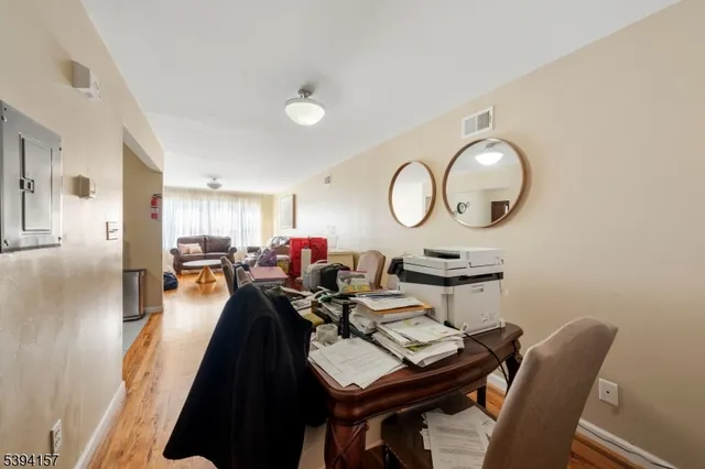 a living room with furniture a mirror and a window