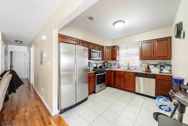 a kitchen with stainless steel appliances granite countertop a refrigerator and a stove