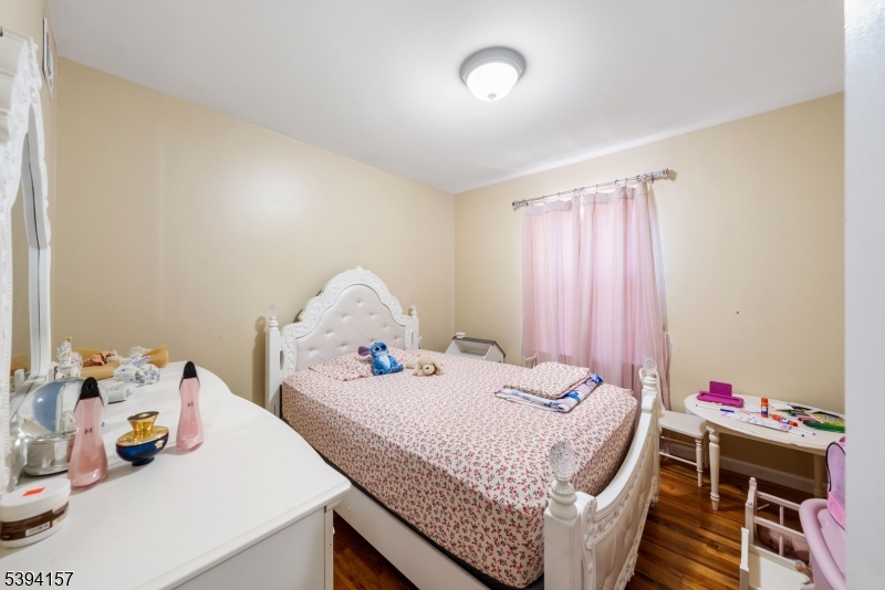 1073 Bond Street Elizabeth, NJ 07201 - Photo 10 of 30 a bedroom with a bed and a table