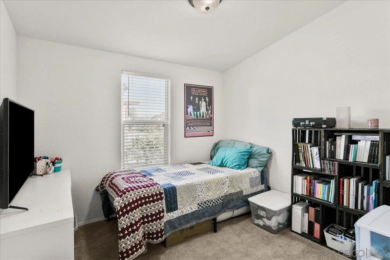 9100 Single Oak Drive Lakeside, CA 92040 - Photo 20 of 28 a bedroom with a bed furniture and a book shelf