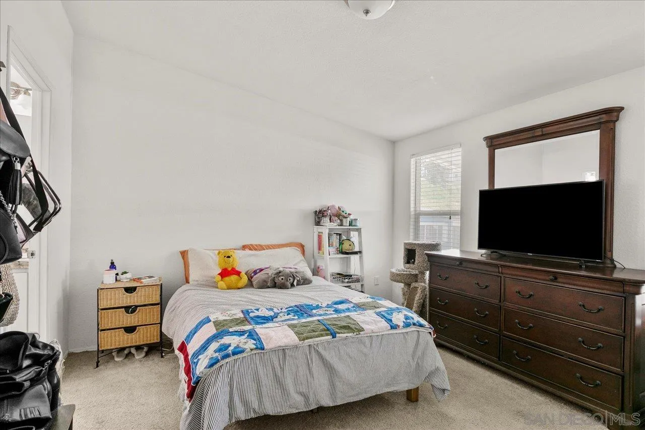 9100 Single Oak Drive Lakeside, CA 92040 - Photo 22 of 28 a bedroom with a bed and a flat screen tv