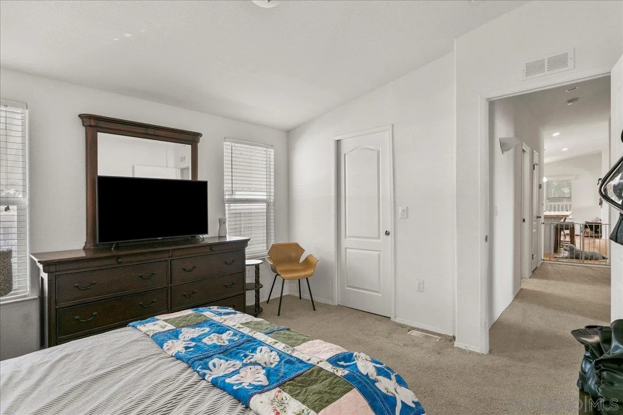 9100 Single Oak Drive Lakeside, CA 92040 - Photo 24 of 28 a bedroom with a bed and a flat screen tv