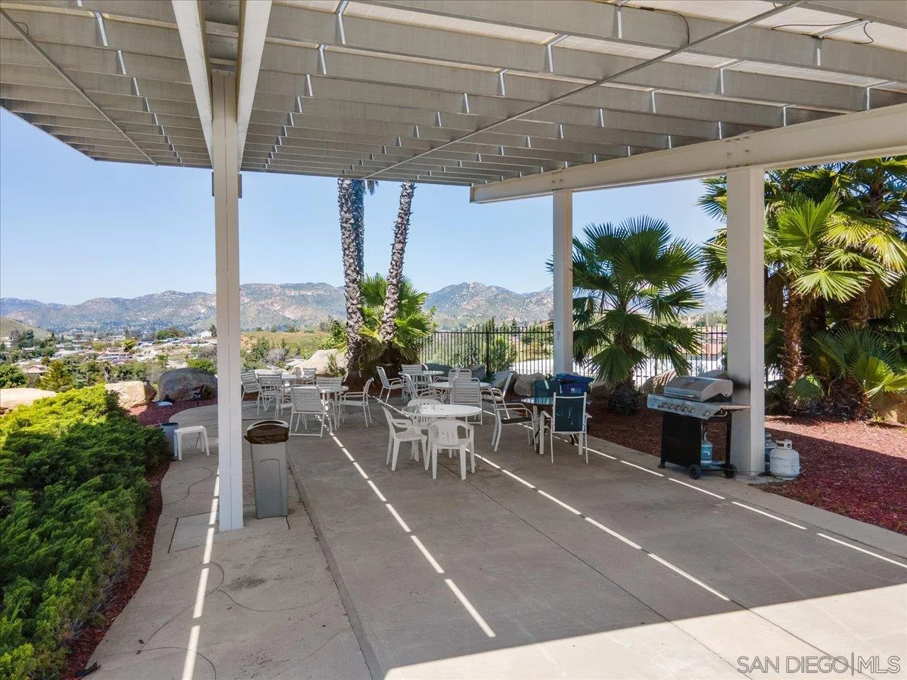 9100 Single Oak Drive Lakeside, CA 92040 - Photo 28 of 28 a view of a patio with plants and table under an umbrella
