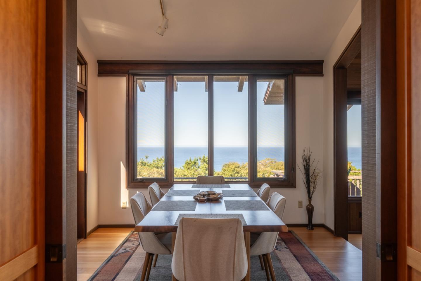 214 Crest Road Carmel, CA 93923 - Photo 6 of 29 a view of a city from a dining room with furniture and window
