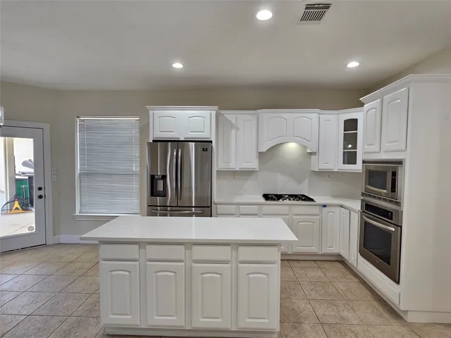 a view of kitchen with kitchen island a sink and wooden floor