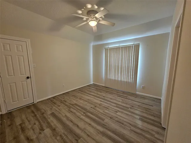 a bathroom with a toilet sink vanity and mirror