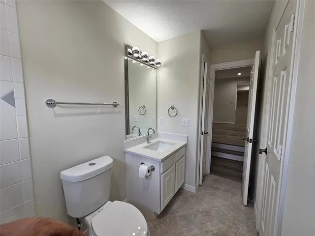 a bathroom with a double vanity sink toilet and shower