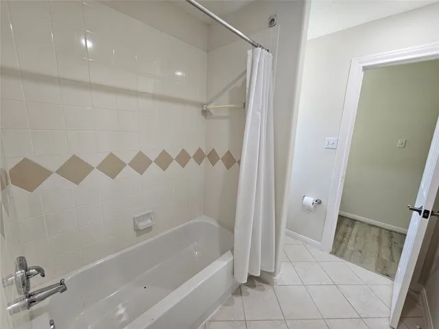 a bathroom with a shower and a sink
