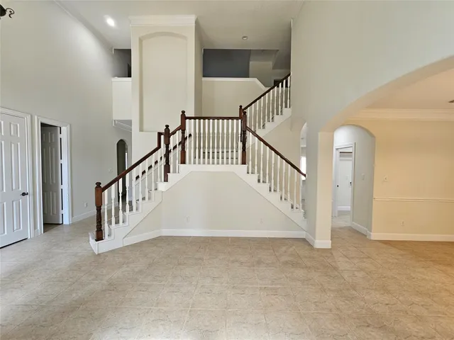 a view of staircase with white floor and white walls