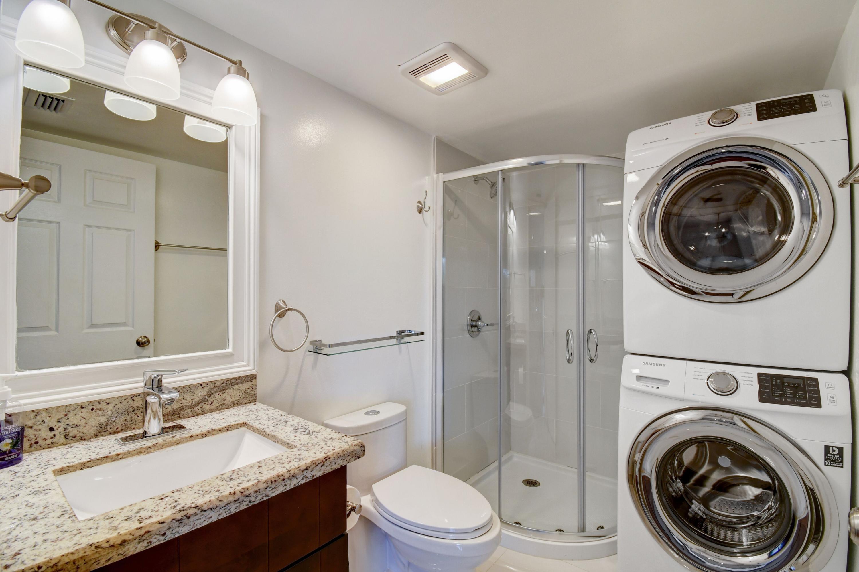8253 Boca Rio Drive Boca Raton, FL 33433 - Photo 4 of 15 a bathroom with a granite countertop toilet sink and mirror